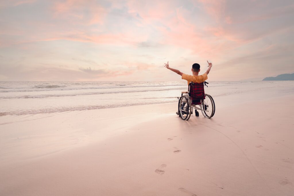 Disabled child on wheelchair on the beach